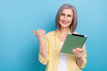 Canvas Print - Photo of positive dreamy lady wear yellow shirt texting modern gadget thumb empty space isolated blue color background