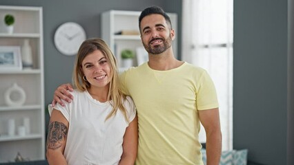 Wall Mural - Man and woman couple hugging each other standing at home