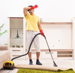 Wall Mural - Young handsome man doing housework