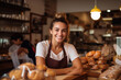 A delighted and smiling young woman manages the bakery, ensuring customers receive the finest baked goods