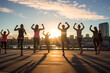 In the tranquil ambiance of the early morning, a dedicated group of women, dressed in vibrant workout attire, gathers in an urban setting to engage in a collective fitness routine