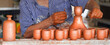 Hands of a male potter creating ceramic dishes from clay on a potter's wheel