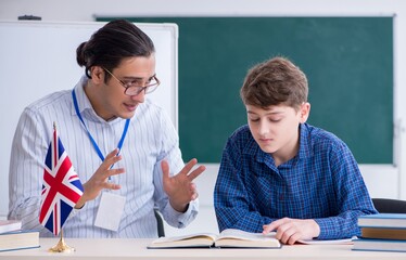 Wall Mural - Male english teacher and boy in the classroom