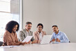 © insta_photos - International diverse professional executives business team workers and board leaders group using laptop computer discussing corporate management working in office collaborating at group meeting.