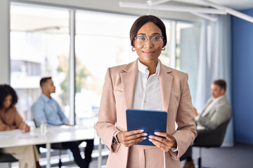 Wall Mural - confident african american businesswoman manager standing at office team business meeting. portrait 