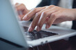 © tippapatt - Close up of business woman hand typing on laptop computer keyboard with reflection on digital tablet on office table, online working, surfing the internet, distant job, remote work concept
