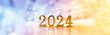 New Year holiday background. Golden numbers 2024 with bright glowing lights.