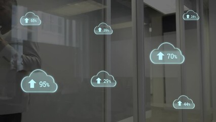 Poster - Animation of cloud upload icons against african american businessman talking on smartphone at office