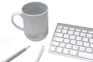 a cup of coffee on the desk, between a keyboard and a clipboard