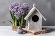 Wooden bird house near the potted hyacinth flower. Welcome spring season with birds and blossom flowers. Generate ai