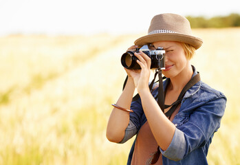 Canvas Print - Woman, camera and photography with safari, vacation and holiday with wheat field and plants. Nature, photographer and outdoor with traveler blog and countryside with photo for adventure and journey