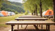 © adynue - empty table with defocused background at camping site with tents