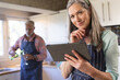 © Wavebreak Media - Portrait of happy senior caucasian couple cooking dinner, using tablet in kitchen