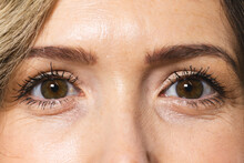 Close Up Of Face And Brown Eyes Of Caucasian Woman With Blond Hair