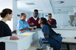 © Wavebreak Media - Happy diverse male and female doctors celebrating birthday at reception desk at hospital