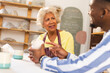 © Wavebreak Media - Two happy diverse female and male potters discussing about job in pottery studio