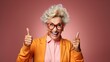 © Iona - studio portrait, an older excited woman in trendy clothes makes the 'ok' sign gesture. She is isolated against a blue background, emphasizing her expression and the hand gesture. Sale, discount, promo