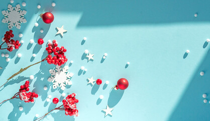 Poster - Beautiful light blue Christmas background with red berries and snowflakes. New Year's composition with decorations for Happy New Year.