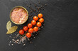 Bef meat in metal can, canned meat, open can, close up, black background, space for text, cherry tomatoes pepper and see salt