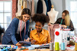 © Art_Photo - Portrait of young african american woman and young girl fashion designer stylish sitting and working with color samples.Attractive two designer girl work with colorful fabrics at fashion studio