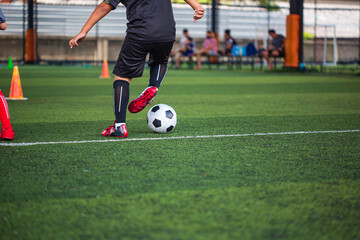 Wall Mural - Children playing control soccer ball tactics on grass field with for training