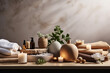  Beauty treatment items for spa procedures on wooden table and marble wall. massage stones