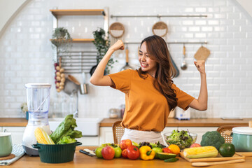 Wall Mural - Portrait of beauty body slim healthy asian woman having fun cooking and preparing vegan food healthy eat with fresh vegetable salad, vegetarian on counter in kitchen at home.Diet.Fitness, healthy food