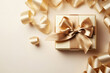 Fashion background with golden gift or present box decorated ribbon top view. Greeting card for Christmas or Birthday.