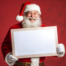 Christmas Santa Claus Holding A Blank Sign, White Placard On A Red Background. Xmas Communication Frame. Santa Doing Dude With Sign With A Christmas Message.
