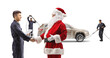 © Ljupco Smokovski - Santa claus and worker shaking hands in front of a SUV at the car wash