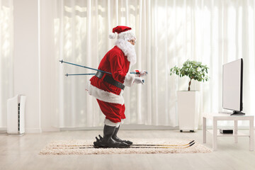 Sticker - Santa Claus skiing at home