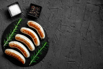 Wall Mural - German sausages on the grill on stone background with copy space for your text