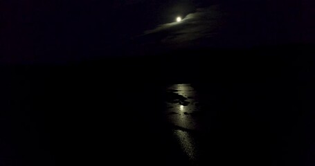 Wall Mural - Aerial view flying over a river at night, beautiful moon view, reflection on water.