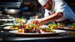 © Aram - male chef decorating dish with tasty food at table in kitchen