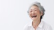Close up photo of an 80-year-old Chinese woman laughing with Alzheimer disease on white background.
