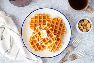 Wall Mural - Plate of tasty waffles with maple syrup on white background