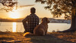 back view of a man with a dog sitting on a rock and watching the sunset