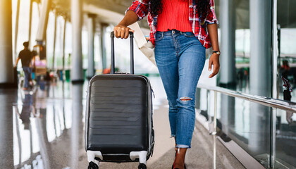 woman traveller dragging black suitcase luggage bag walking to passenger boarding in airport, Travel concept