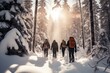 Candid shot of a group of people snowshoeing through a snowy forest.