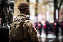 A Soldier Standing In Front Of A Statue With His Back Turned To The Camera And Looking Away From The Camera