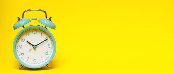 Wall Mural - vintage retro alarm clock Four o'clock, ten minutes on  yellow background.