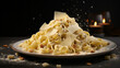 A plate of freshly-made pasta, tossed in a creamy sauce and topped with a sprinkle of cheese