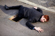 © Mariusz S/peopleimages.com - Portrait, accident and an unlucky business man on a street in the city after falling into a hole. Mistake, stuck or clumsy and a ginger corporate professional on the road in a suit with a problem