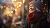 Fototapeta Uliczki - A joyful elderly woman wearing a winter hat and scarf, amidst a vibrant cityscape illuminated with festive lights. Perfect for holiday campaigns, articles, or family-themed content.