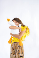 Teenage girl embracing toy. Childhood, toys and kids. Cute teen girl cuddling favorite fluffy toy. Happy teenager, positive and smiling emotions of teen girl.