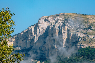 Wall Mural - Clouds lingering on the limestone cliffs of the Glandasse mountain in Vercors, near Chatillon en Diois in the south of France (Drome)