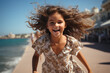© Roman - Little girl running along the sea promenade with flying hair
