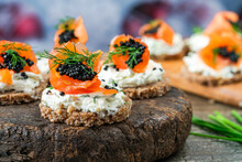 Cocktail Canapes With Smoked Salmon, Cream Cheese And Caviar On Rye Bread - Gourmet Party Food.