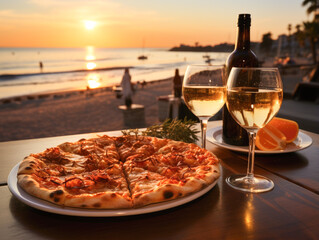 A luxury restaurant with a sea view at sunset sets the scene for indulging in pizza and sipping white wine.