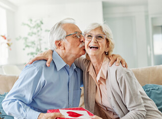 Wall Mural - gift woman man couple happy love happiness present kiss romantic smiling together box wife husband e
